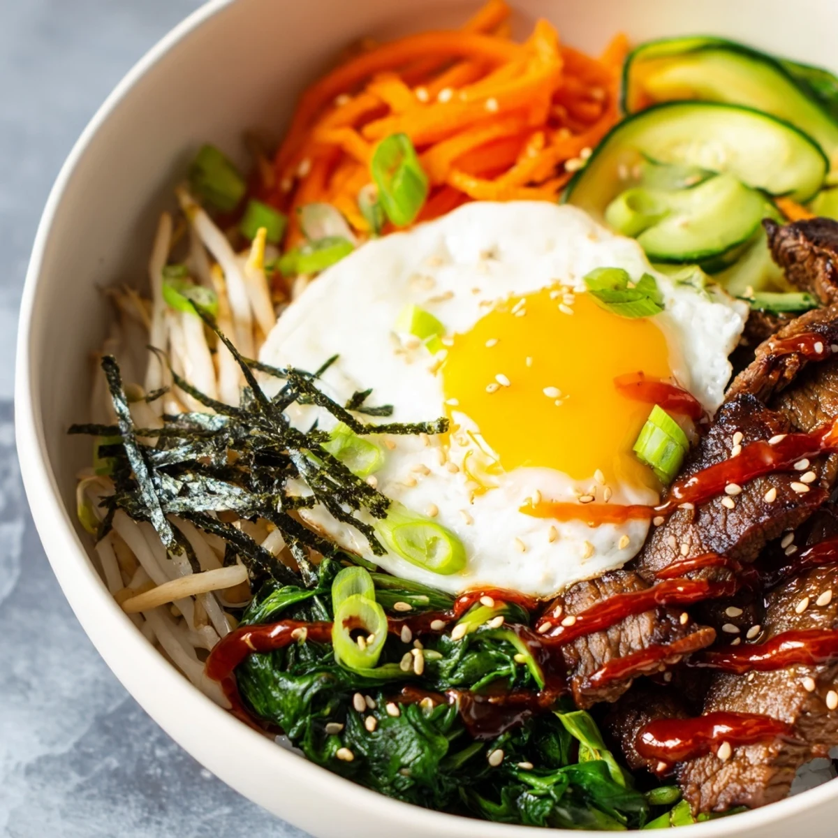 Savory Korean-inspired breakfast bowl with marinated beef and fresh vegetables over rice