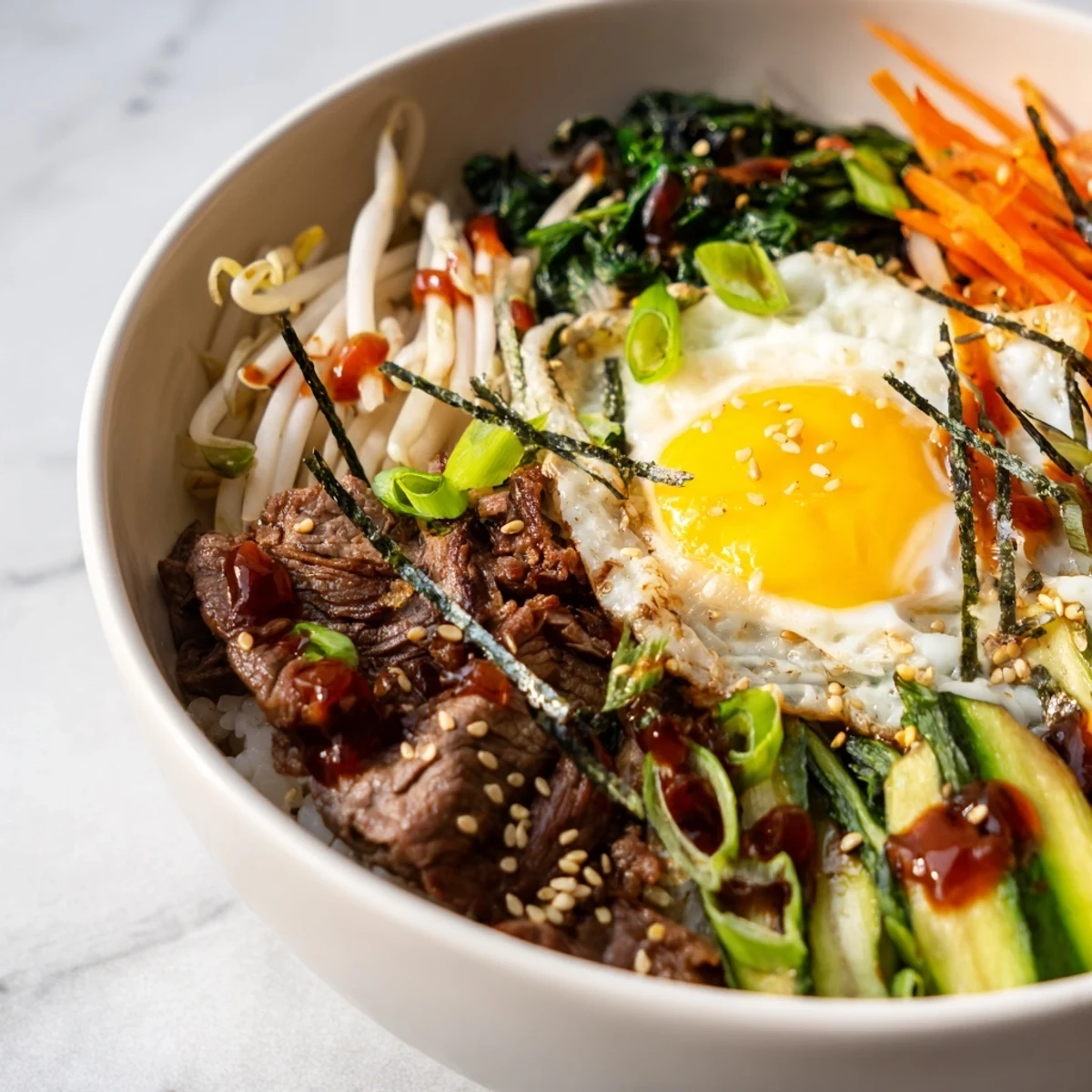 Vibrant Korean-inspired breakfast bowl featuring runny egg and crispy vegetable toppings