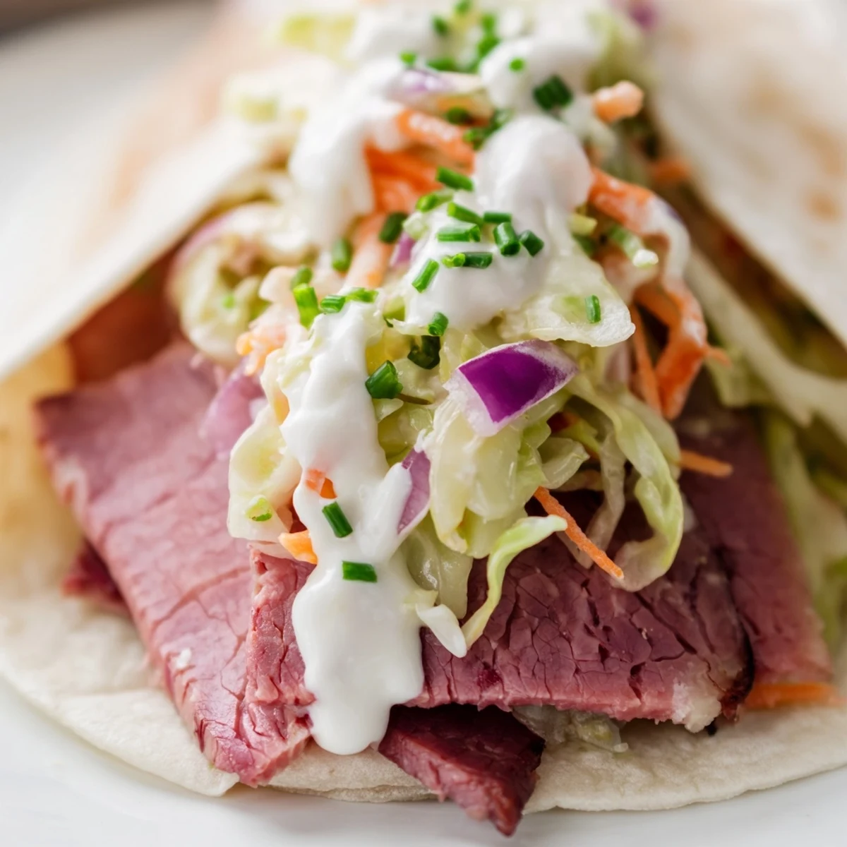 Fresh Irish tacos topped with horseradish sauce and crisp vegetable slaw