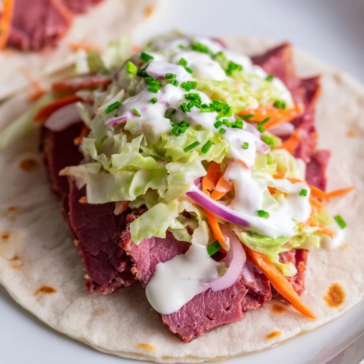 Soft tortilla wraps layered with tender corned beef and colorful shredded cabbage