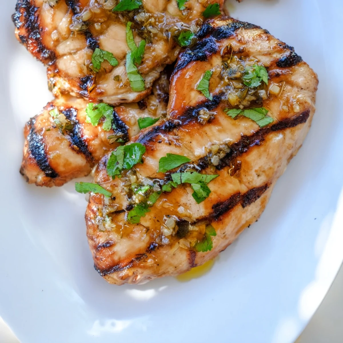 Tender juicy Key West grilled chicken with honey lime glaze and green sprinkles on a dinner plate