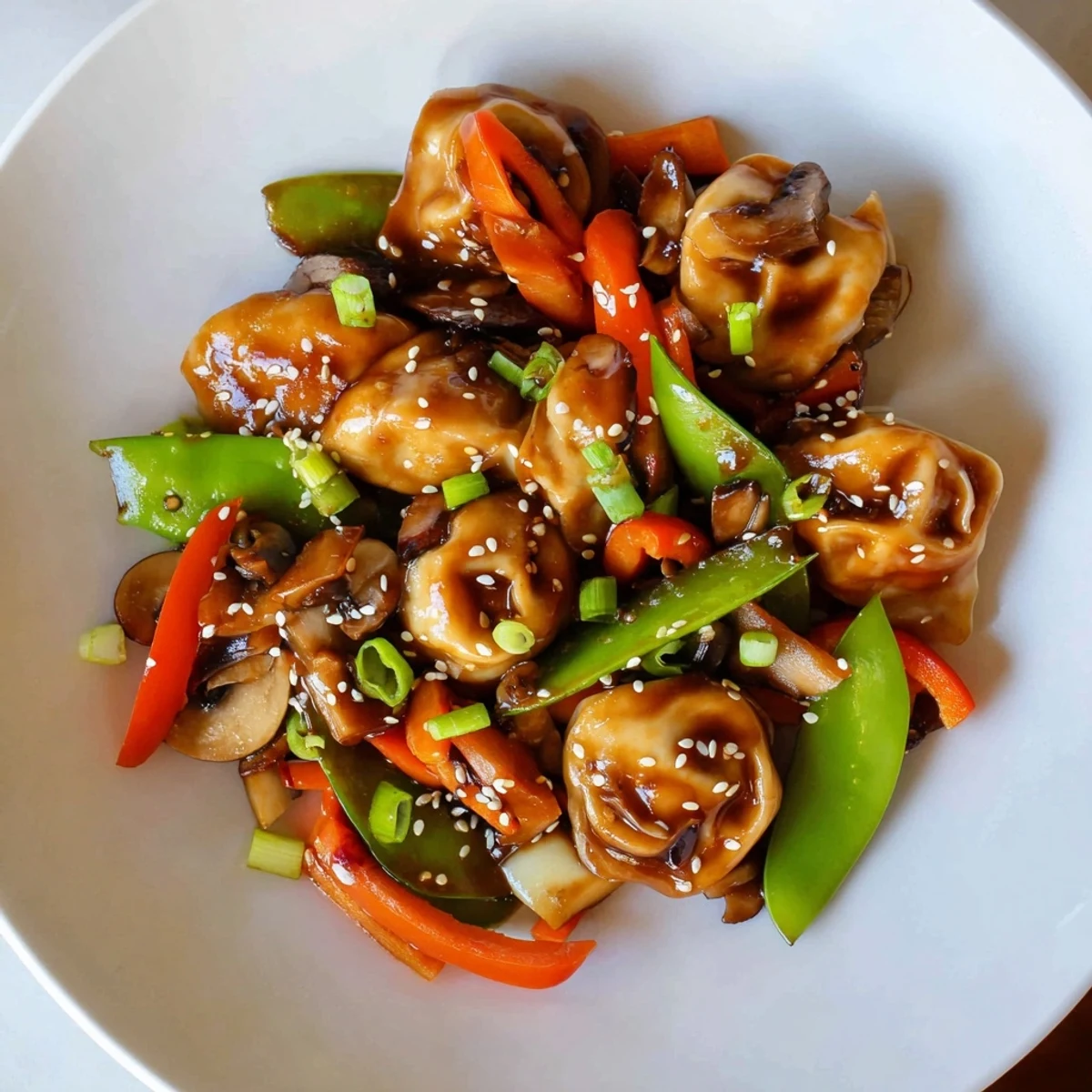 Crispy-bottomed dumplings stir-fried with fresh vegetables and sesame seeds for a quick dinner