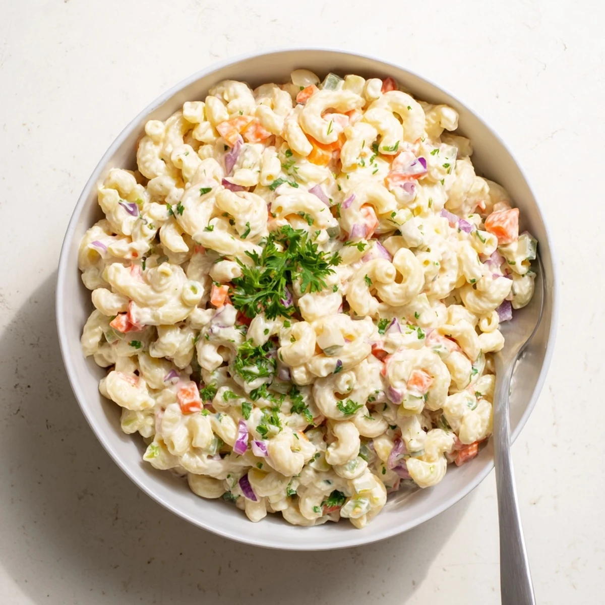 Creamy Tangy Macaroni Salad with colorful diced vegetables in a white serving bowl