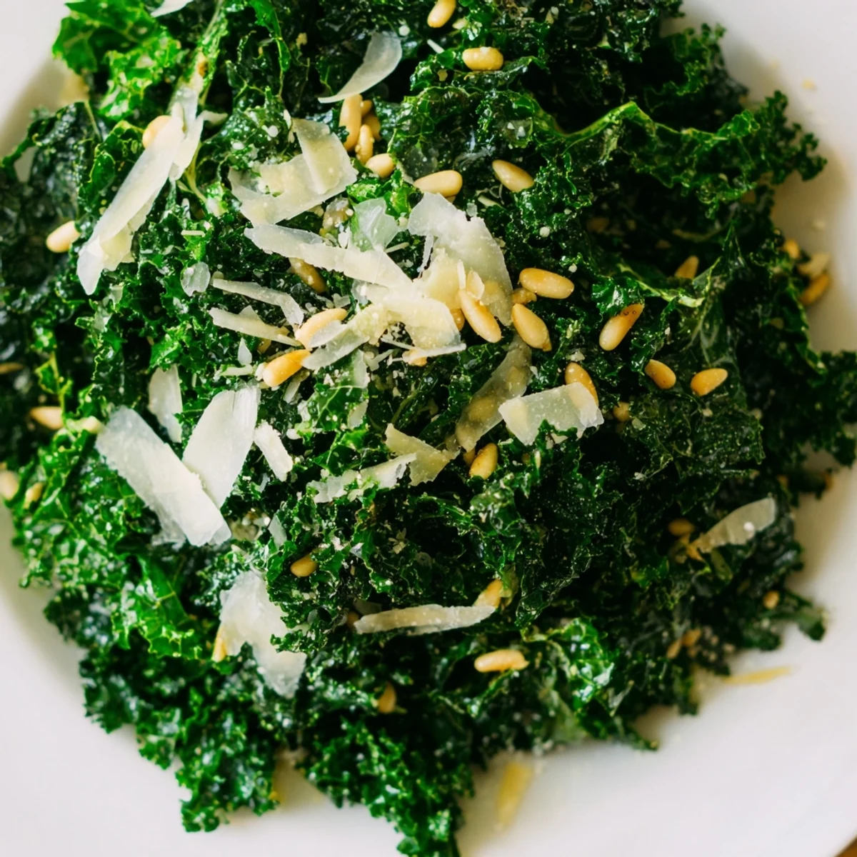 Vibrant massaged kale leaves glistening with zesty Garlic Lemon Parmesan Kale Salad dressing.