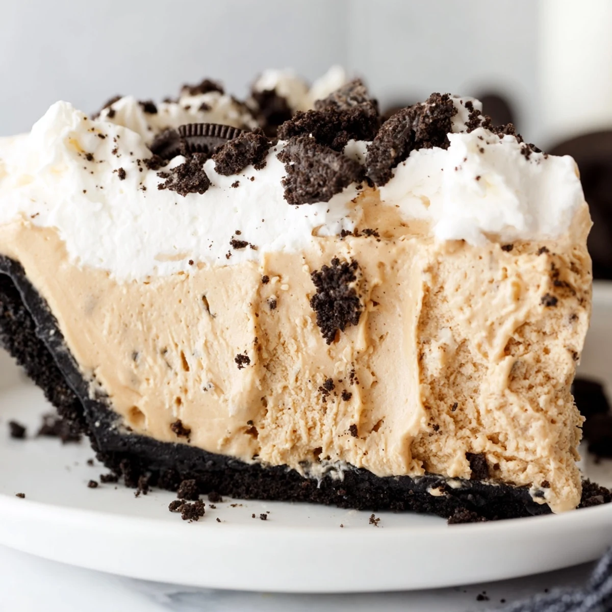 A rich peanut butter Oreo pie in a chocolate crust ready to serve at gatherings