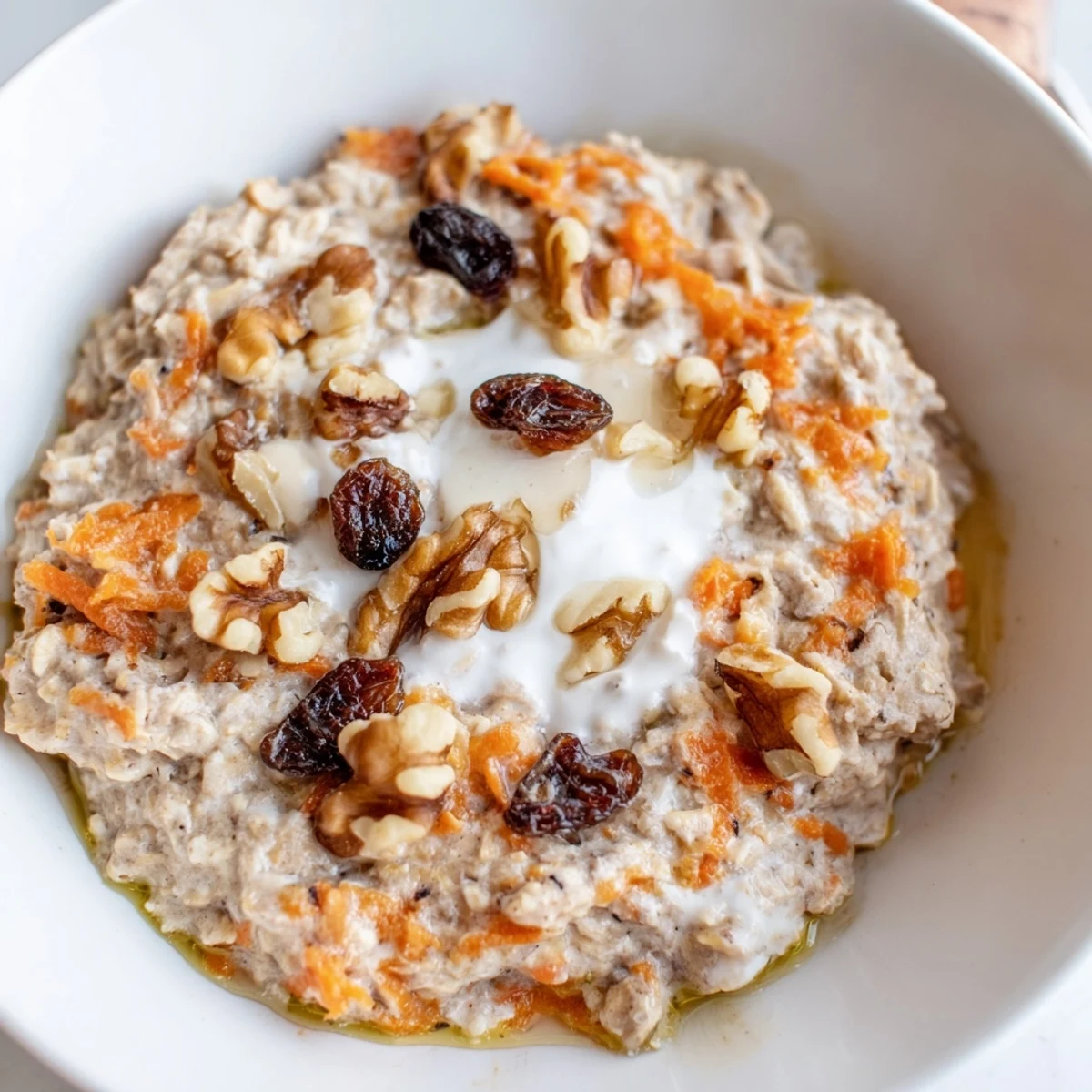 Creamy carrot cake overnight oats topped with crunchy walnuts and a drizzle of maple syrup