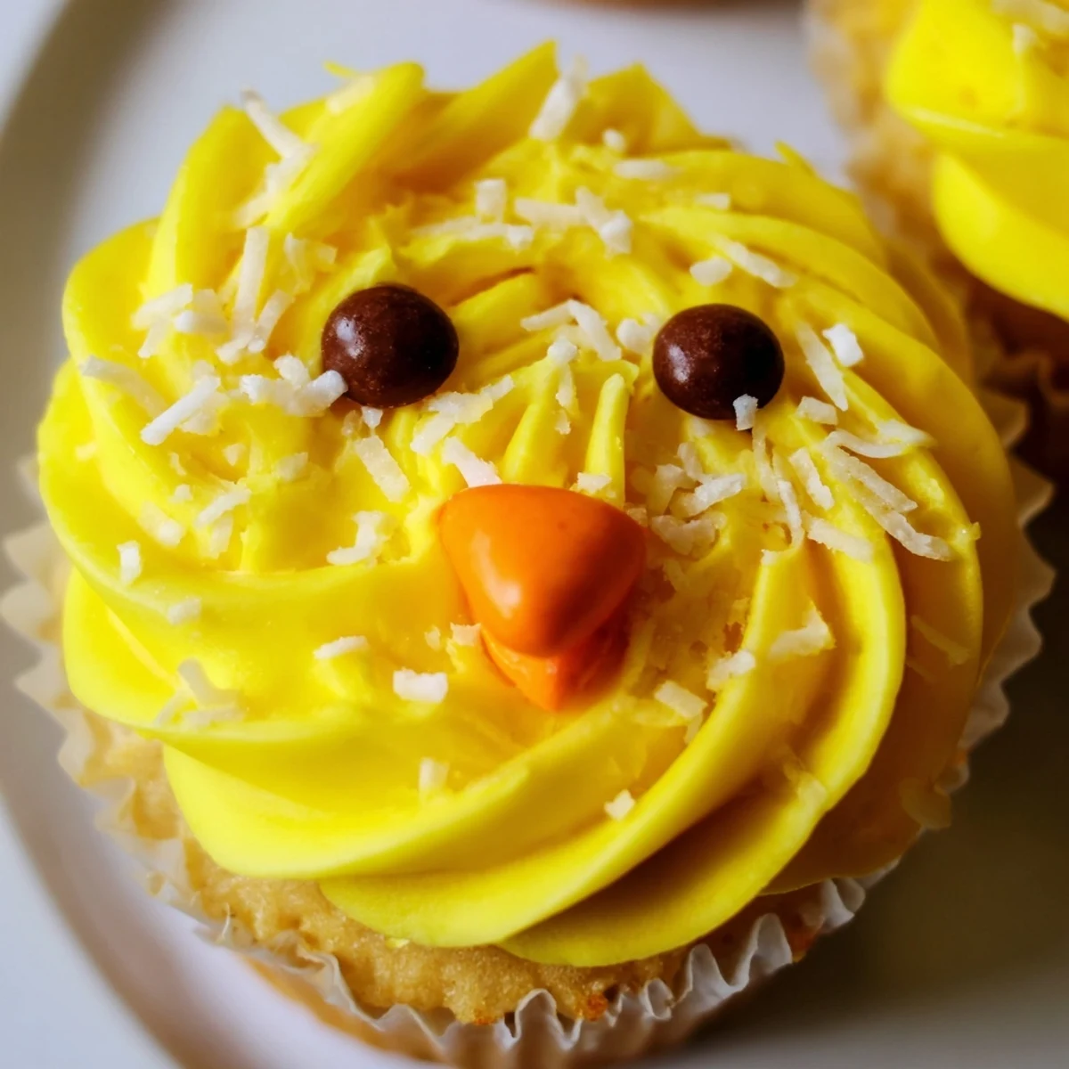 Adorable Easter Chick Cupcakes with fluffy yellow frosting and sweet candy faces on display