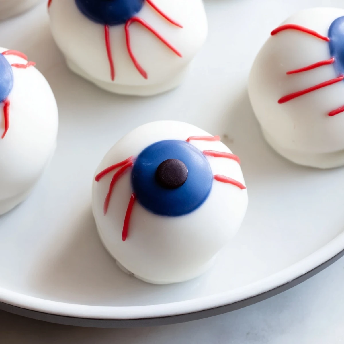 Round Halloween Cake Eyeballs coated in glossy white chocolate with colorful iris details