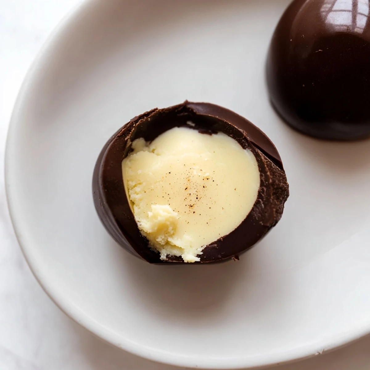 Hand-rolled Dark Chocolate Eggnog Truffles chilling on tray, creamy centers visible