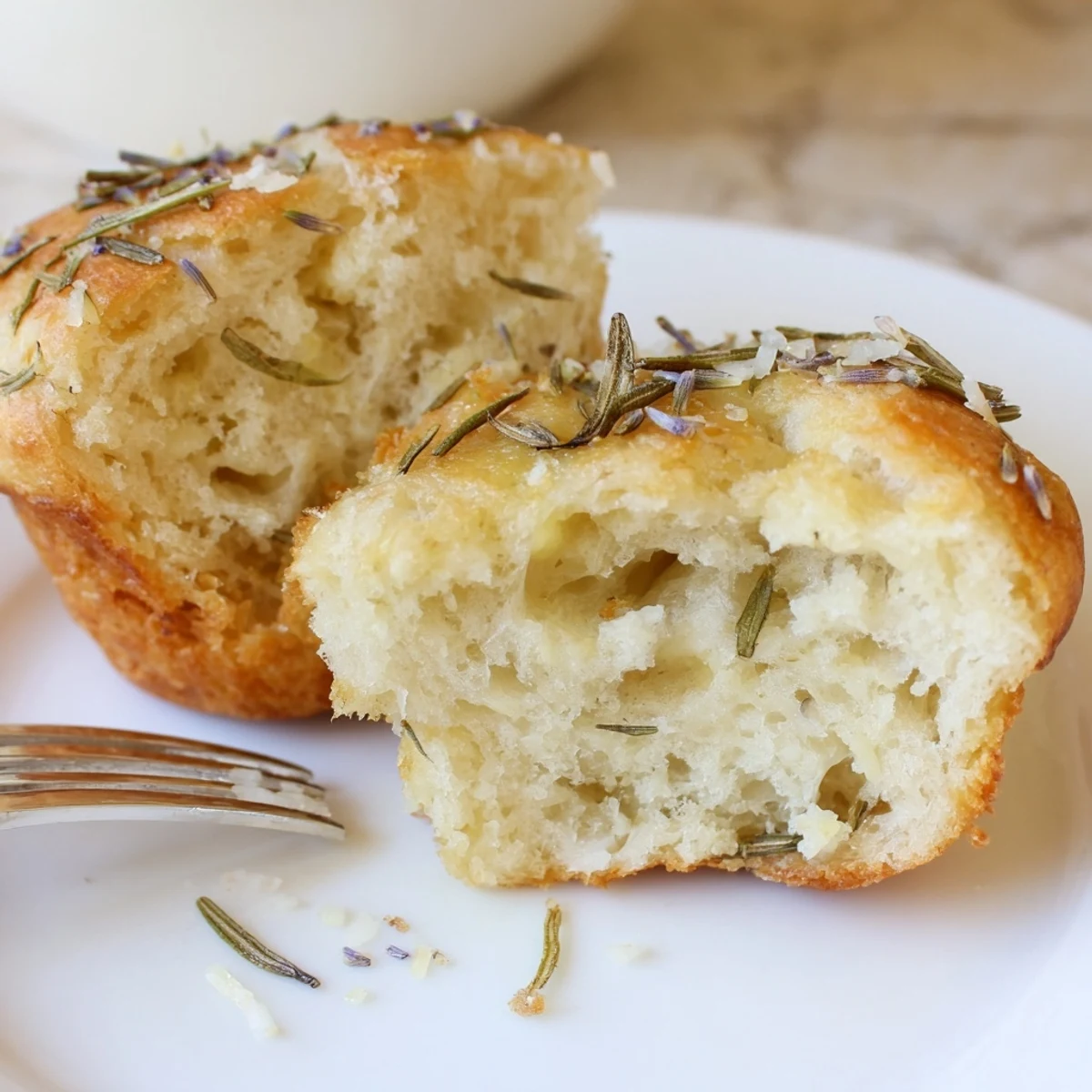Garlic Rosemary Focaccia Muffins with golden tops, olive oil sheen and flaky salt