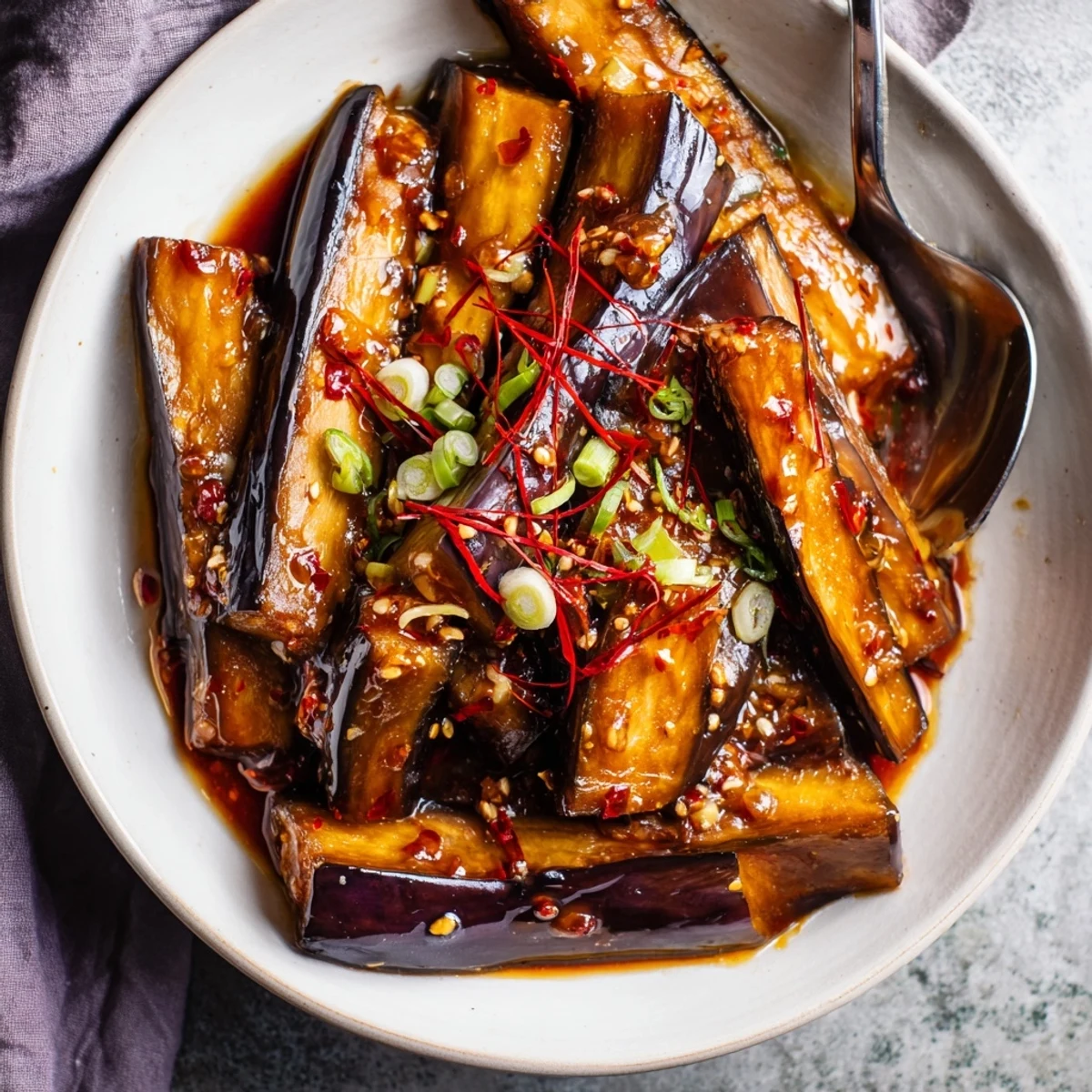 Steaming Sichuan Style Braised Aubergines piled over fluffy jasmine rice, aromatic