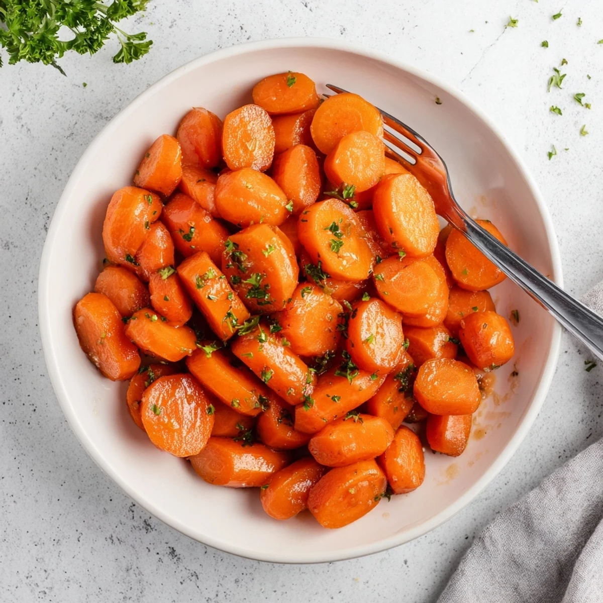 Close up of sweet honey glazed carrots arranged neatly on rustic wooden serving board