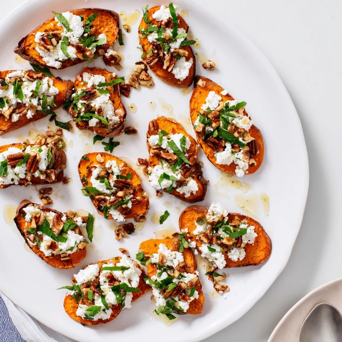 Golden roasted sweet potato rounds topped with crumbled feta cheese and sweet honey drizzle