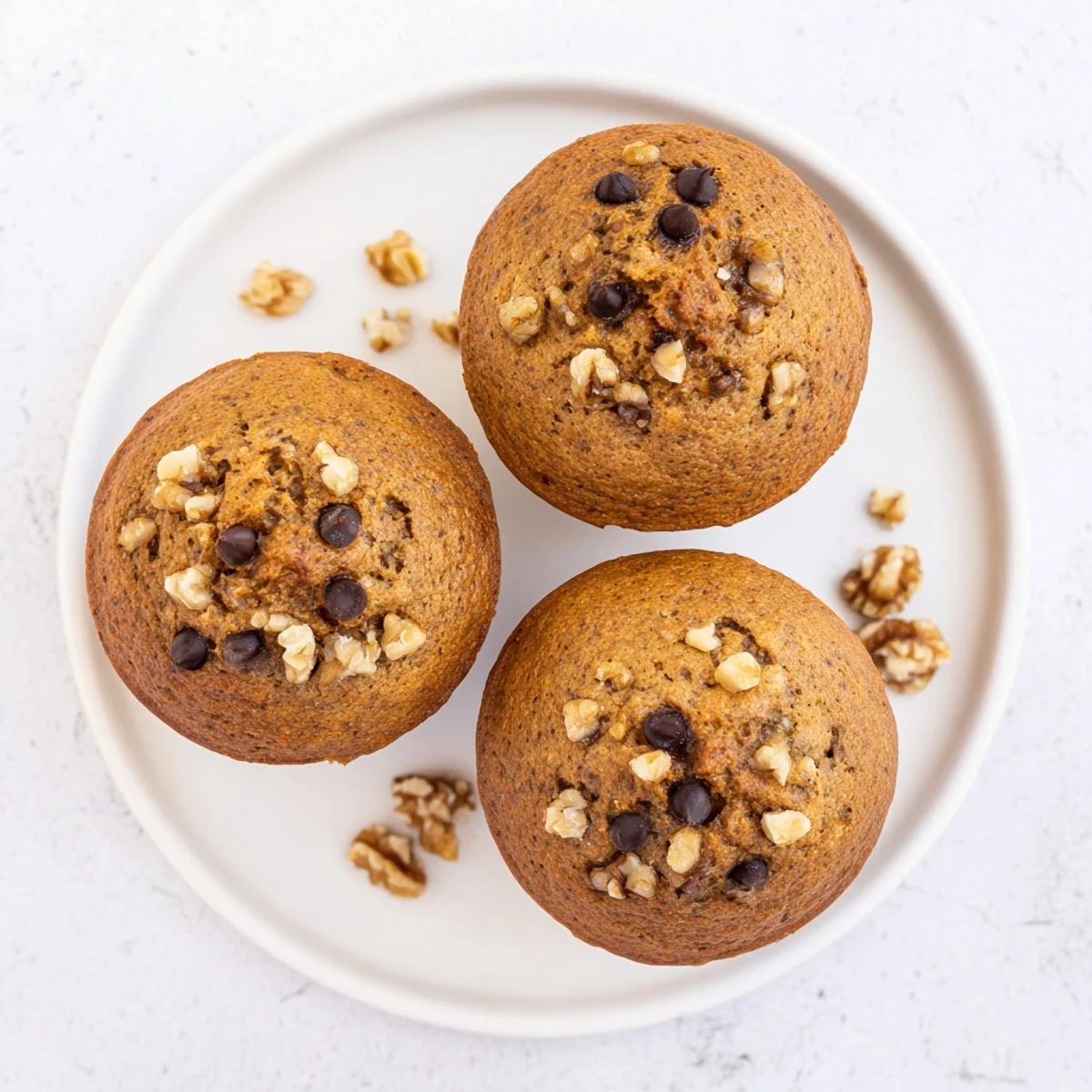 Moist whole wheat Healthy Banana Nut Muffins studded with nuts ready for breakfast or snack