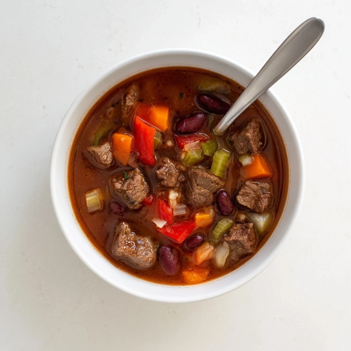 Savory beef and bean soup delight served piping hot with kidney beans and vegetables in a thick, flavorful beef broth