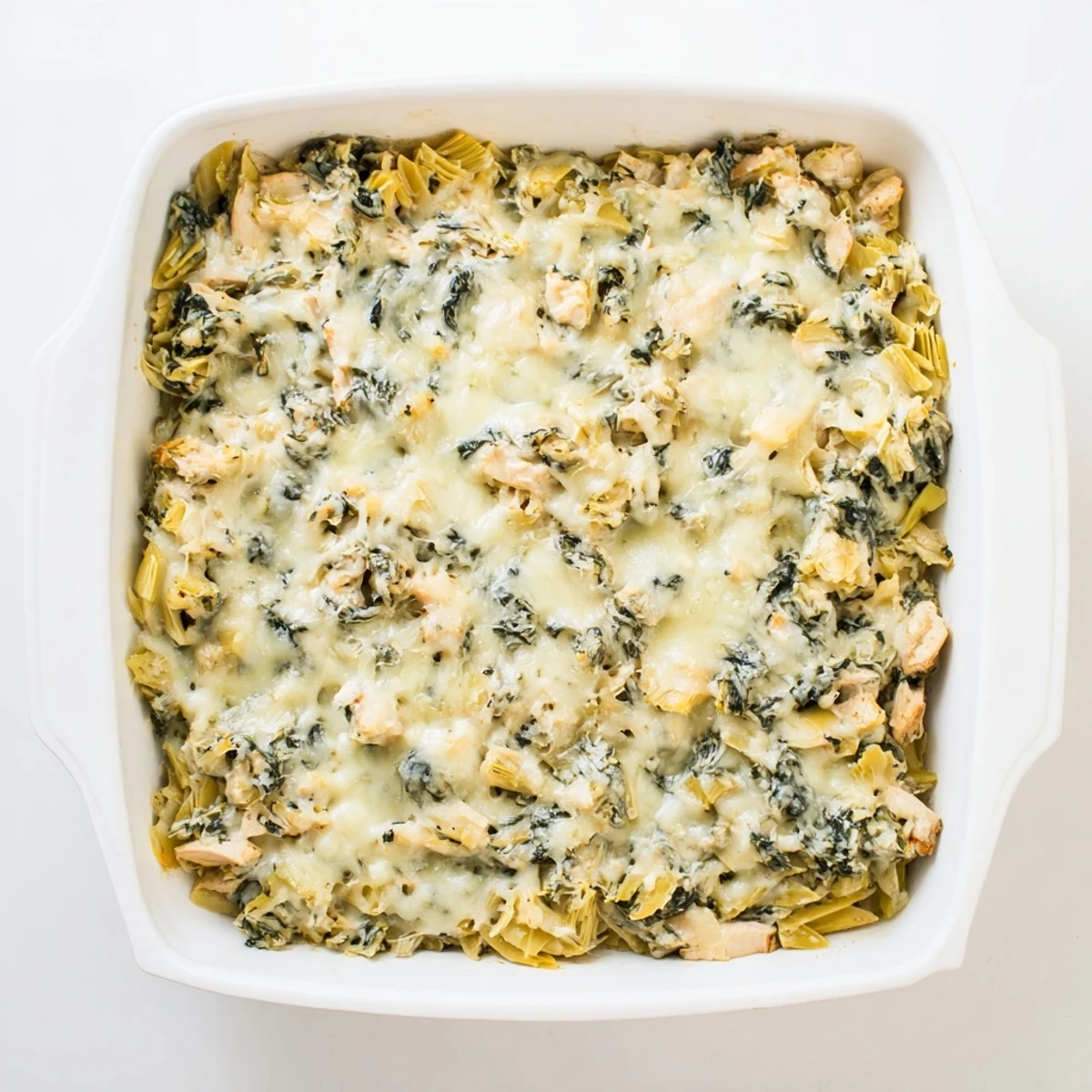Savory chicken spinach and artichoke casserole baked until bubbly with a crispy mozzarella crust