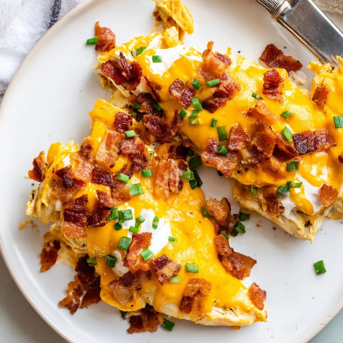 Golden bubbling baked crack chicken with crispy bacon and melted cheddar cheese