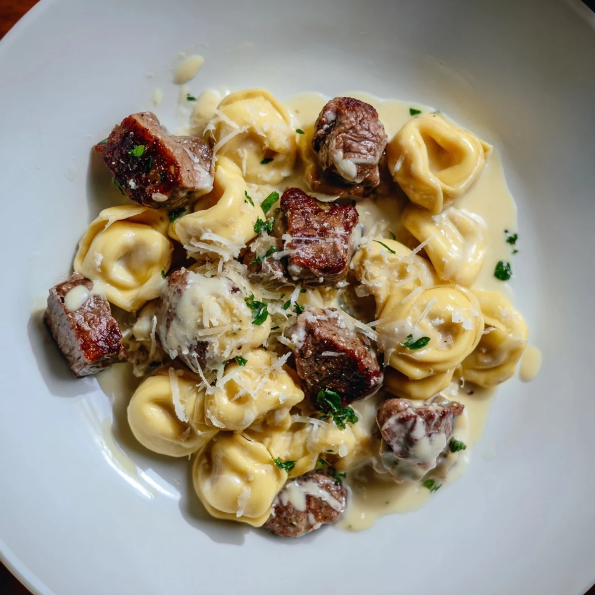 Creamy garlic steak tortellini in a golden parmesan sauce topped with fresh parsley